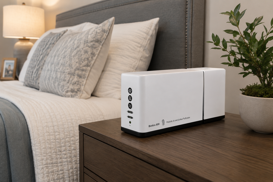 EnviroBiotics Biotica 800 probiotic air and surface purifier operating on a bedroom nightstand in a modern home.