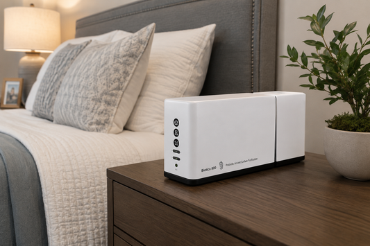 EnviroBiotics Biotica 800 probiotic air and surface purifier operating on a bedroom nightstand in a modern home.